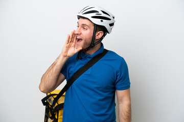 Young caucasian man with thermal backpack isolated on white background shouting with mouth wide open to the lateral