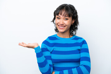 Young Argentinian woman isolated on white background holding copyspace imaginary on the palm to...