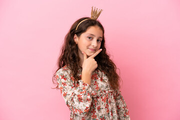 Little caucasian princess with crown isolated on pink background having doubts © luismolinero