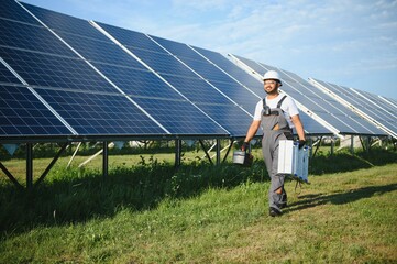 Indian worker installing solar panels. Concept of alternative, renewable energy