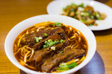 Taiwanese spicy red soup beef noodle in bowl