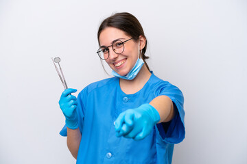 Dentist caucasian woman holding tools isolated on white background pointing front with happy...