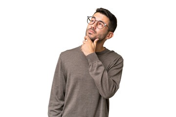 Young handsome caucasian man over isolated background having doubts