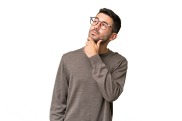 Young handsome caucasian man over isolated background having doubts