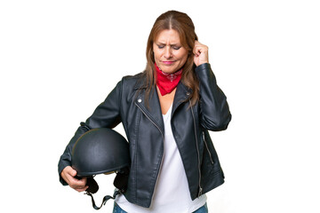 Middle-aged caucasian woman with a motorcycle helmet over isolated background frustrated and covering ears