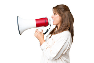 Middle age woman over isolated background shouting through a megaphone