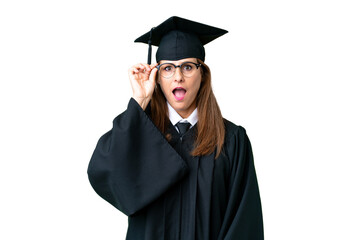 Middle age university graduate woman over isolated background with glasses and surprised