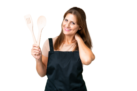 Middle age caucasian woman holding a rolling pin over isolated background laughing