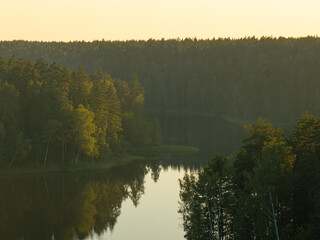 Golden hour over the forest lake