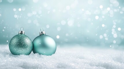 Fototapeta premium snow background with light green baubles ornaments on light teal background