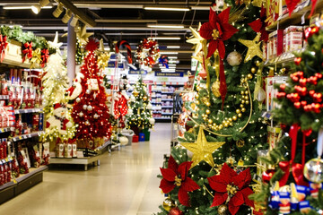 Christmas-themed store aisle filled with beautifully decorated trees, ornaments, and festive items,...