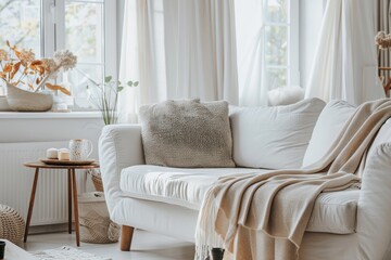 Fototapeta premium Light and airy living room with white furniture and a cozy sofa