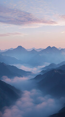 Fototapeta premium A Serene Dawn: Layers of Mist Blanket a Majestic Mountain Range, Casting a Mystical Glow Across the Landscape.