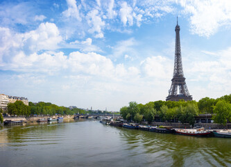 Obraz premium View of Eiffel Tower and river Seine with a blue sky in Paris, France. 