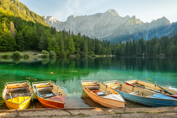 Picturesque Laghi di Fusine lake with colorful boats