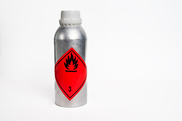 Aluminum bottle for sampling with flammable liquids label, white background.