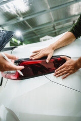 Car seller agent signs a car insurance agreement with salesman. The document outlines vehicle policy, premium, rental terms, with contract paper finalized using car insurance claim mobile phone.