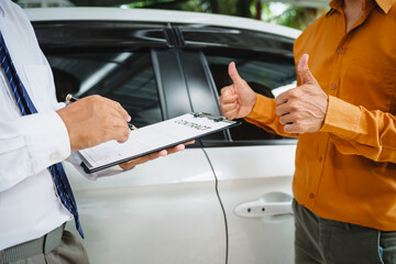 Car seller agent signs a car insurance agreement with salesman. The document outlines vehicle...