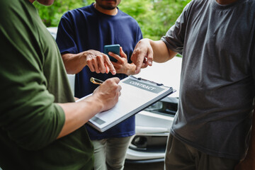 Three Asian men discussing car insurance policies with adjuster. They review details such as premiums, deductibles, coverage options while handling recent claim and evaluating the settlement process.