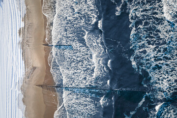 Snowy beach and Baltic sea in winter. Tourism in Poland.