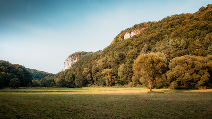 Beautiful autumn landscape. The setting sun illuminating the limestone rocks. Bedkowska Valley. Jura. Poland