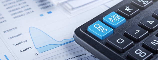 calculator and financial charts. Investment and capital accumulation concept