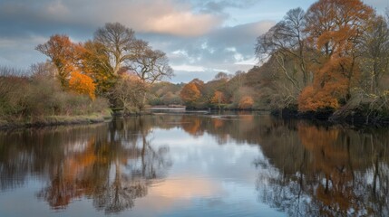 Obraz premium Serene Autumn Lake Reflection with Colorful Trees and Cloudy Sky in Peaceful Nature Setting