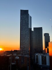 Manchester skyline at sunset with modern buildings and landmarks. Manchester England. 