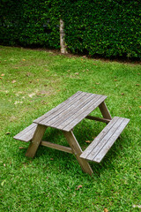 Old wooden table in green garden