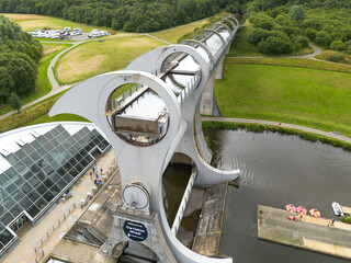 Aerial drone photo of the rotating Falkirk wheel transporting lifting narrow boats in the Forth and Clyde canal with engineering master piece in Scottish highlands