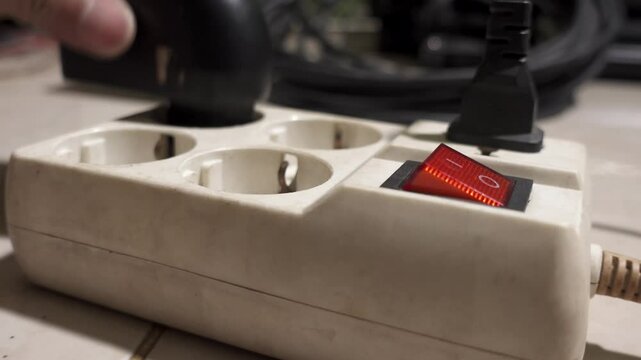 Multiple wires plugged in power socket. Concept of short circuit, fire hazard electricity.