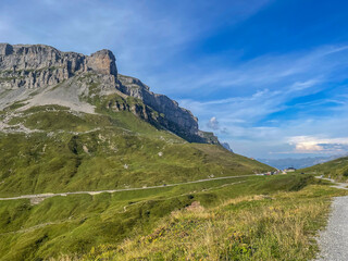 mountain pass road top with chappelle and parking, hiking paths in summer, cliffs and summit of the Clariden mountain Swiss alps, Klausenpass, Switzerland