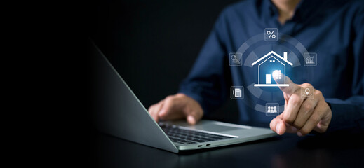 Fototapeta premium Real estate investment concept . Businessman use laptop with house icon for analyzing mortgage loan home and insurance real property mortgage. business real estate.