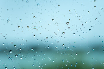 Close-up of water drops on glass in rainy season. Pattern. Background.