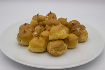 Cream-filled Profiteroles on White Plate