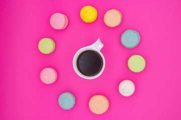 Vibrant Macarons with Black Coffee on Pink Background