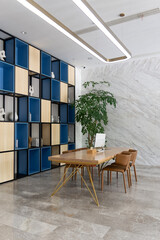 computer on wooden table and chairs in room