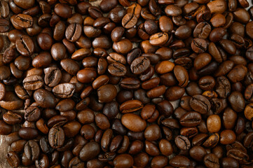 Closeup of dark roasted coffee arabica beans with smooth aroma and ripe taste