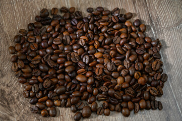 Close-up of coffee beans with roasted beans on table