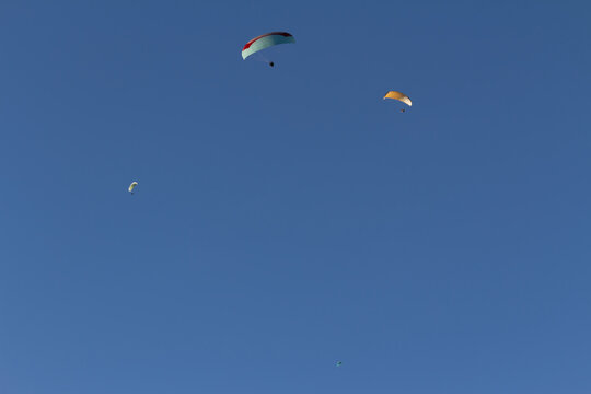 Paraplan and deltaplan in alps over a ski resort