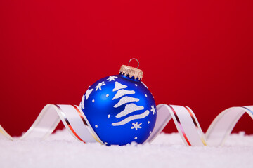 christmas colorful balls over the snow with a red background