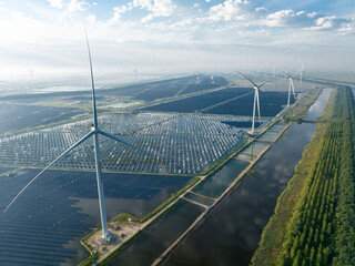 view of solar power station and wind turbine over sea