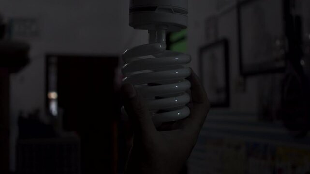 Turn off the spiral bulb in the living room. Screw the bulb to turn off the light. Tornado Compact fluorescent Spiral bulb
