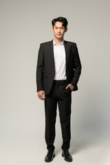 Portrait of Happy asian man wearing suit over white background