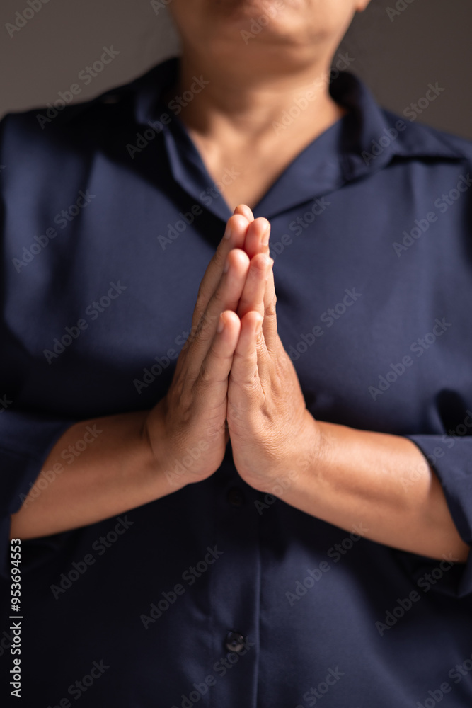 Wall mural woman prays with faith, her hands clasped in devotion, seeking guidance of jesus christ and god in h