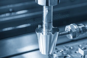 The close up scene the sinker EDM machine operation in the light blue scene.