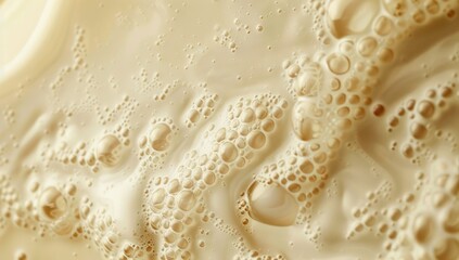 A close-up of milk being poured, with delicate bubbles forming in the liquid
