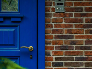 blue restored retro entrance door on a brick house close up