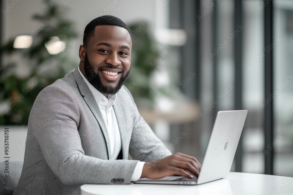 Poster a professional business meeting environment featuring a smiling man engaged in productive work on a 
