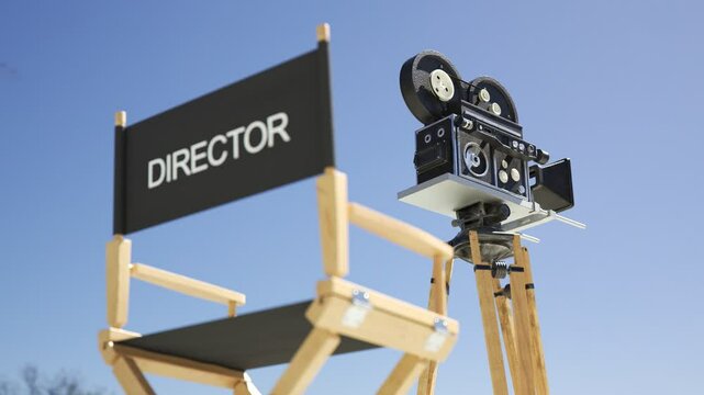 Old Retro Vintage Film Camera With Director Chair In The Background Old Retro Vintage Film Camera With A Black Fabric Director Chair In The Background Bright Light Illuminates A Reel Case Shoving Holl